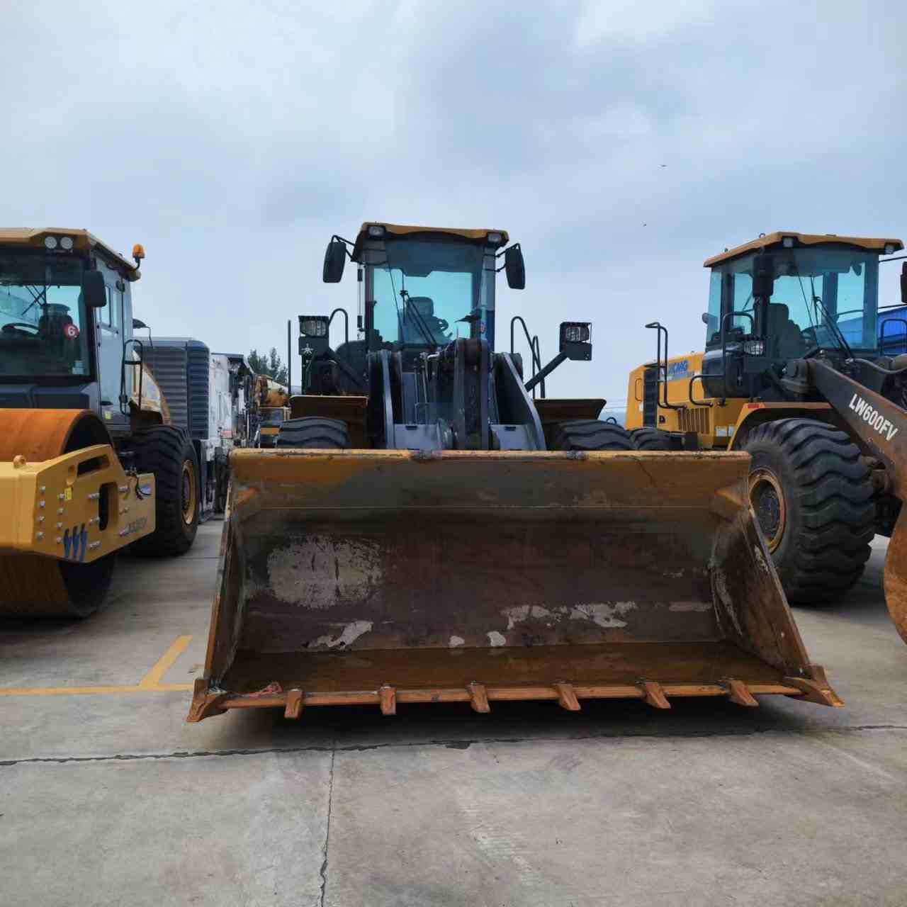 Newly used wheel loader and truck mounted crane waiting for refurbishment